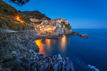 Manarola town on the coast of Ligurian Sea at dusk, Italy