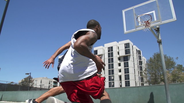Two Basketball Players Playing One on One Outside with Scoring