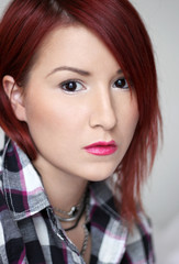 Redhead young woman in plaid shirt portrait