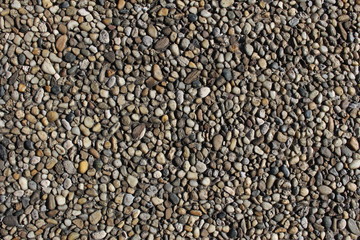 Pebbles-embedded stone texture as a background