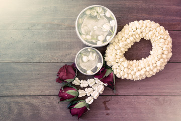 beautiful Thai garland flowers (jasmine and roses) and water in