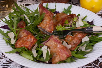 Grilled bacon with parmesan cheese and arugula