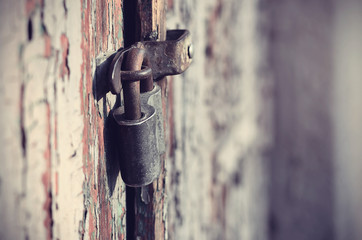 Closeup photo of a padlock on wooden door