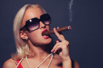 Blond girl smoking cigar © Fxquadro