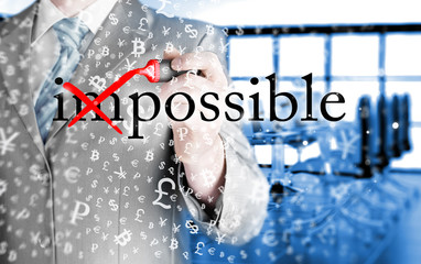 Businessman Hand turning the word Impossible into Possible with