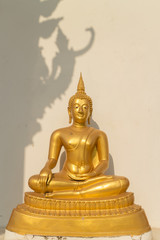 the sitting gold buddha statue under sunlight with deva image