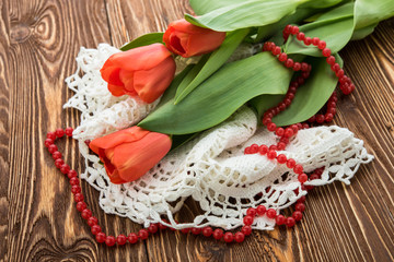 red tulips on wooden background