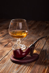 Glass of brandy and a pipe