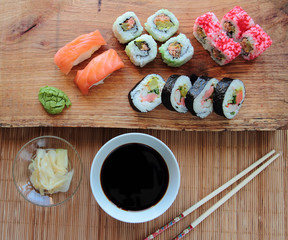 Mix of sushi with soy sauce and wooden chopsticks