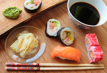 Sushi rolls with soy sauce and wooden chopsticks