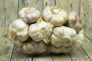 group of garlic on wooden plank, still life style