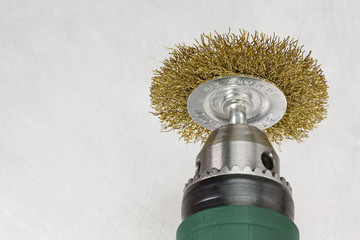 Closeup drill head with rotating brass brush