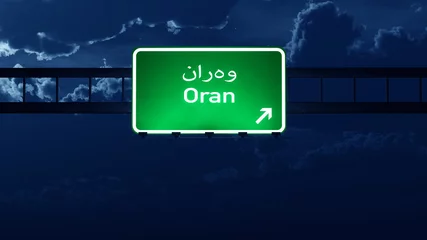 Foto op Aluminium Oran Algeria Highway Road Sign at Night © boscorelli