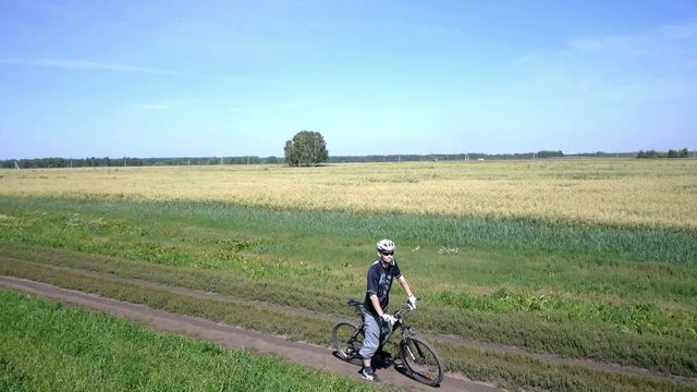 Man cycling on a rural road. Aerial view.