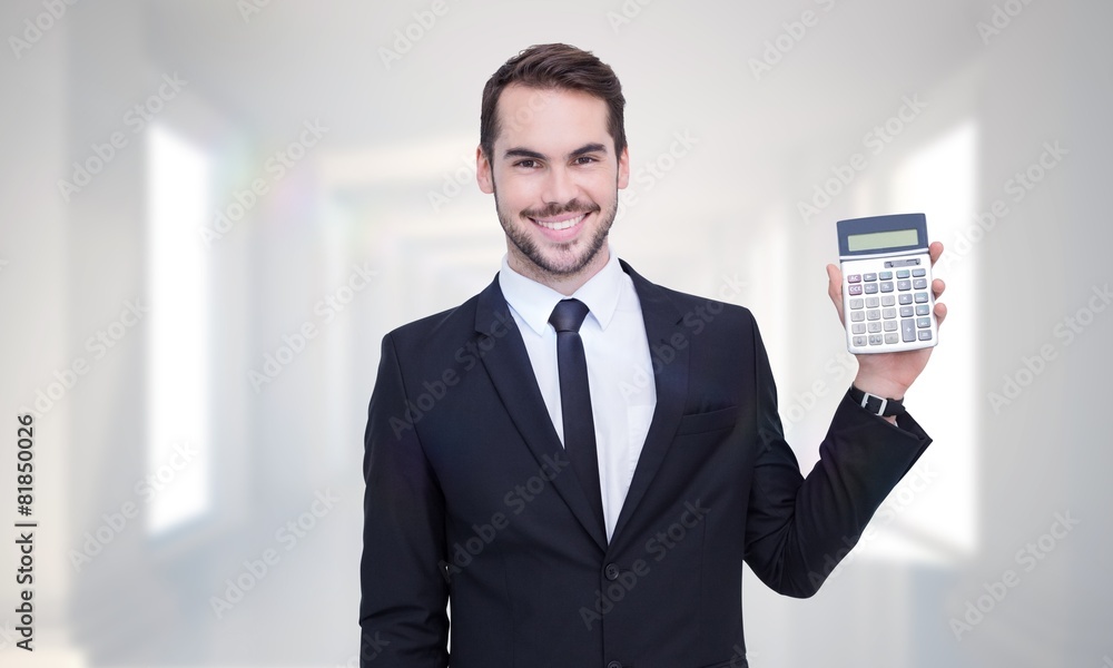 Poster composite image of smiling businessman presenting a calculator