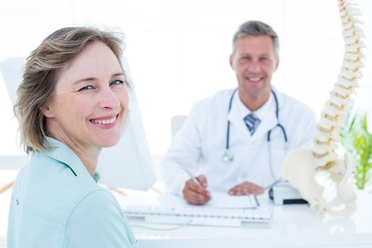 Patient and doctor smiling at camera