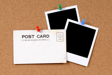 Old postcard or post card vintage retro pinned to a cork board background with two blank polaroid style photo frame prints © david_franklin
