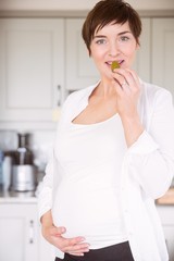 Pregnant woman eating jar of pickles