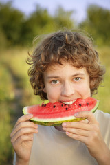 happy teenager eating watermelon