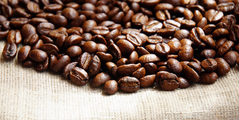 Background from coffee beans on fabric closeup