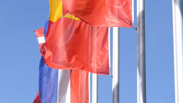 Europ&auml;ische Fahnen im Wind vor blauem Himmel, Zeitlupe