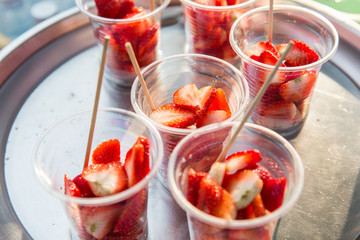 strawberry in plastic cups at street market