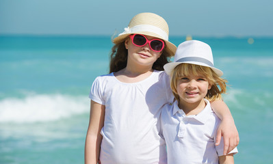 Brother and sister on the  beach enjoying summer vacation