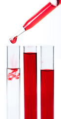 liquid dripping from pipette into test tube isolated