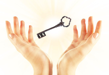 Female hands with key isolated on white