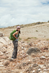 Adult brunette woman hiking and backpacking