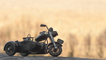 Close-up of miniature toy motorcycle on natural background