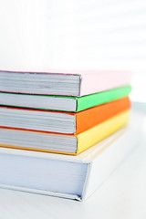 Books on white windowsill, close up