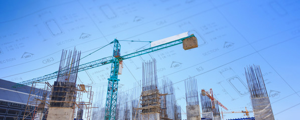 Building crane and construction site under   blue sky