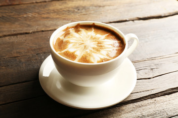 Cup of coffee latte art on wooden background