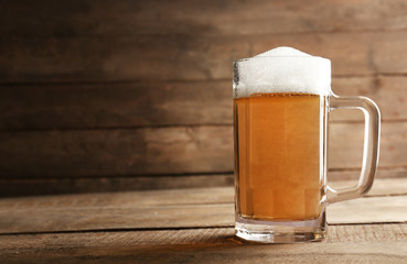 Glass of beer on wooden background
