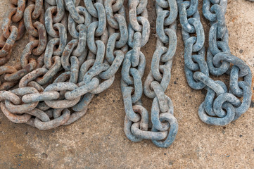 Rusty chain on concrete floor