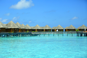 Water villas over blue ocean in baros Maldives