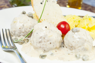 meatballs with potatoes on the table in a restaurant