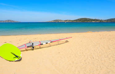Fototapeta na wymiar windsurf board on the sand in Porto Pollo