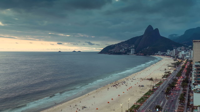 Ipanema Beach transition day to night shoot with people and cars moving in Rio de Janeiro, Brazil