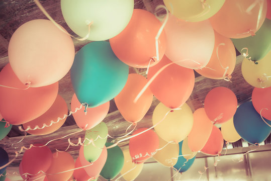 Colorful balloons floating on the ceiling of a party in vintage
