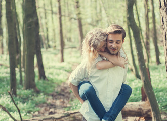 cheerful pair of lovers in summer forest