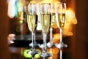 Glasses of champagne on bar background