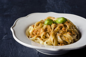 Traditional Italian fettuccine pasta with red Sicilian pesto