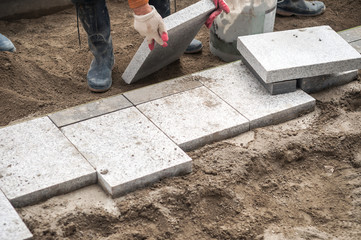 Construction worker installing the pavestone