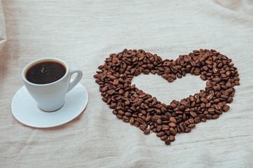 Cup of Coffee. roasted beans in heart shape . isolated on white