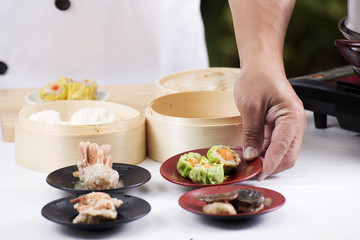 Obraz na płótnie Canvas Chef presented Chinese Dim Sum / Cooking Dim sum concept