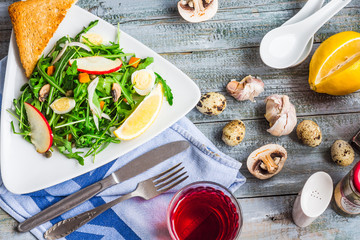 green salad with arugula, mushrooms, quail eggs, pumpkin, capers