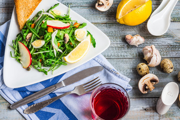 fresh salad with arugula, quail eggs, capers and apple