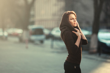 Fototapeta premium The pensive woman in the sunset city